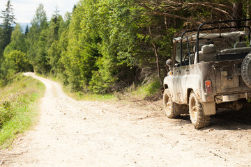 Off road 4x4 adventure, jeep on mountain dirt road. Copy space for text.