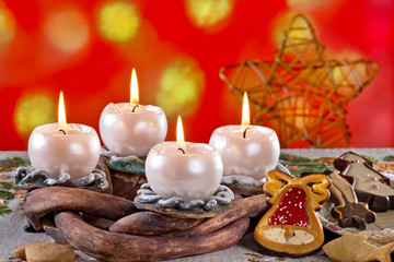 Advent Wreath with Burning Candles on the Red Background