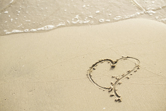 Heart written on the beach in the morning instead of the word love