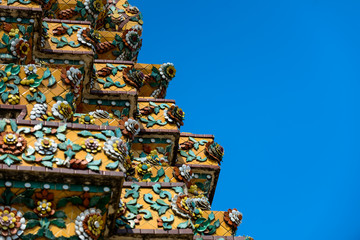 Close up beauitful mosaic tiles of large stupas in Wat Pho or Wat Phra Chetuphon Vimolmangklararm Rajwaramahaviharn is one of Bangkok's oldest temples, THAILAND