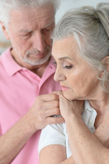 Portrait of sad Senior couple at home