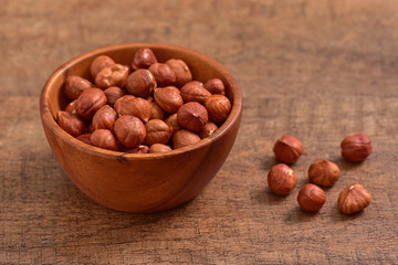 Hazelnuts bowl on wooden background