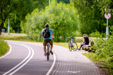 Naklejka premium Cyclist ride on the bike path in the city Park 