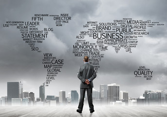 Motivation and inspiration concept with modern cityscape and businessman observing it