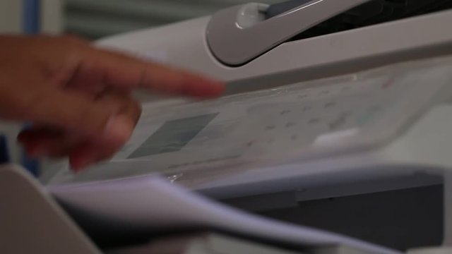 Business office Concept : Hand Businessman is process of press paper on laser print cartridge, lay down or take papers from printer at Busy Offices background