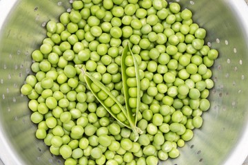 Fresh green peas in a strainer 