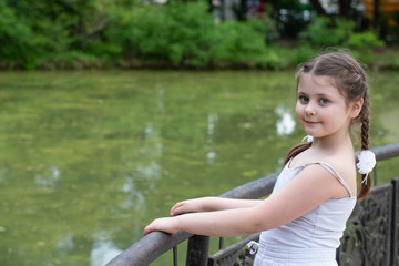 a beautiful girl near the pond