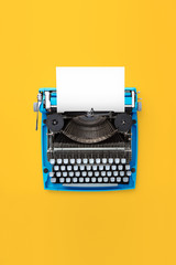 Fototapeta na wymiar Typewriter machine in retro style on yellow background. Top view.