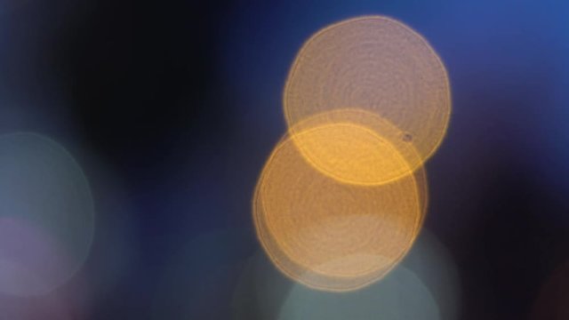 Defocused golden circles light effects, abstract blurred motion boche background