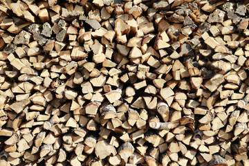 Chopped firewood on a stack. Dry chopped firewood logs in a pile.