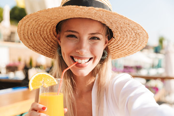 Delighted young girl in summer hat and swimwear