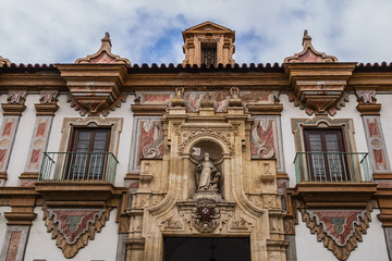 Fototapeta na wymiar Architectural fragments of Baroque Palacio de la Merced in Cordoba Plaza de Colon. Palacio de la Merced was built in XVIII century; it was monastery of Mercedarian monks. Andalusia, Cordoba, Spain.