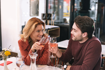 Cheers honey. Happy positive couple drinking wine and talking