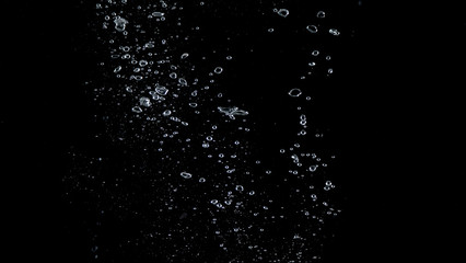 Close-up images of soda water splashing in the water to many little bubbles that make it feel like...