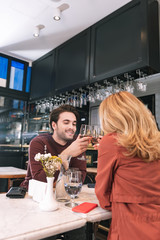 First anniversary. Adorable nice couple drinking wine and conversing