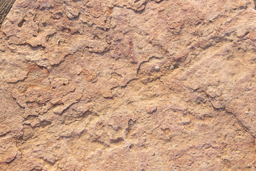 Stone textured background of a reddish brown hue