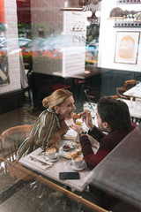 Indescribable taste. Top view of glad mature mature woman opening mouth while man holding fork