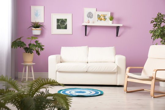 Stylish room interior with comfortable white sofa