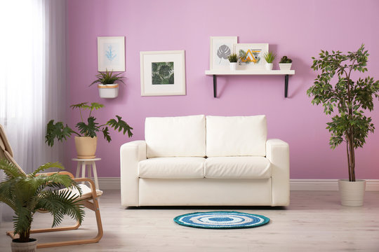 Stylish room interior with comfortable white sofa