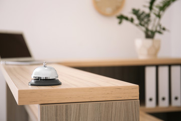 Service bell on reception desk in hotel, closeup