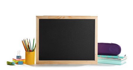 Small chalkboard and different school stationery on white background