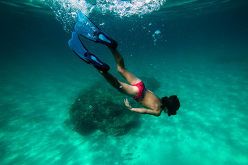 Anonymous boy snorkeling in sea