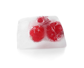 Raw berries frozen in ice cube on white background