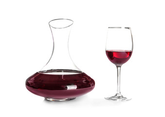 Elegant decanter and glass with red wine on white background