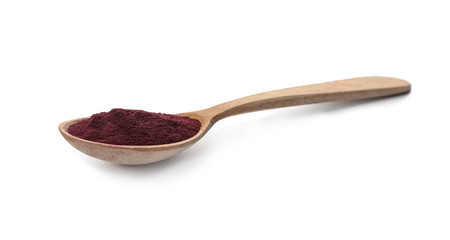 Spoon with acai powder on white background