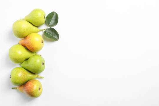 Ripe juicy pears on white background, top view