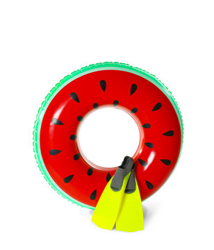 Inflatable ring and flippers on white background. Summer holidays