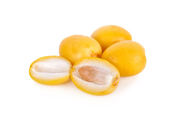 whole and half cut fresh yellow dates on white background