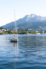 Mountain Pilatus and Sailing boat at Luzern, Switzerland, concept of travel vacation to Europe, vertical photo