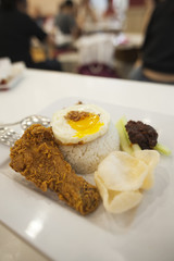 Fragrant rice dish cooked in coconut milk, served with fried chicken, egg, cucumber, sambal chill and prawn crackers