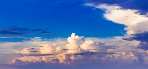 Colored clouds on the background of a blue sky during sunset, a panorama_