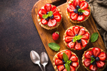Strawberry tart on dark table. Top view.
