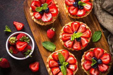 Strawberry tart on dark table. Top view.