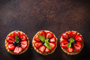 Strawberry tart on dark table. Top view. - obrazy, fototapety, plakaty
