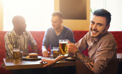 Handsome man drinking beer in pab