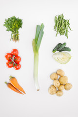 flat lay with various seasonal ripe vegetables with leek in middle isolated on white