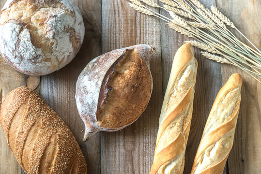 Different kinds of bread on the wooden background