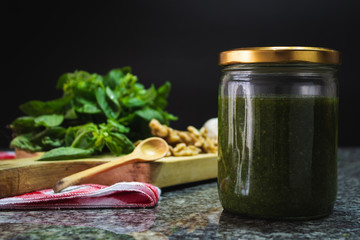 Pesto jar with ingredients