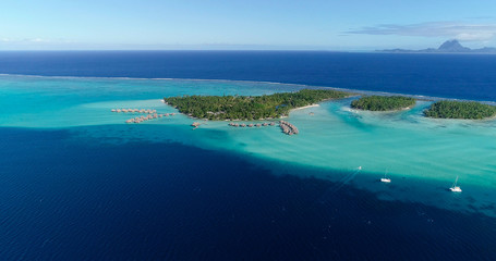 Water bungalows resort at islands, french polynesia in aerial view