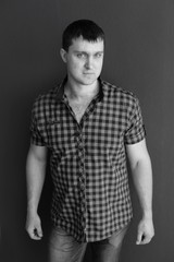 young man in shirt and jeans. portrait of man. black and white male portrait photos