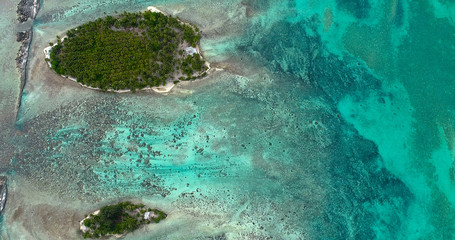 small islands (motu) in the middle of a lagoon in aerial view, French Polynesia