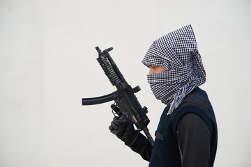 Close up terrorist with gun on white background,Thailand people,A bad guy,He is no good man - obrazy, fototapety, plakaty