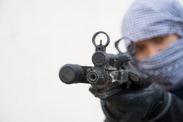 Close up terrorist with gun on white background,Thailand people,A bad guy,He is no good man