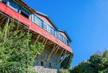 Traditional architecture with wooden and stone walls and balcony of a Greek monastery