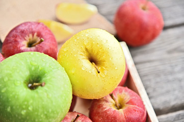 colorful of 3 Type of apple,Gala,Granny Smith,Golden Delicious in wooden box and wooden background.