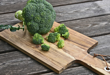 Powerful antioxidant of broccoli stands out as the most concentrated source of vitamin C..Broccoli on wooden floor.